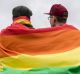 Men with rainbow flags stand in front of the Brandenburg Gate to celebrate the legalisation of same-sex marriage in ...