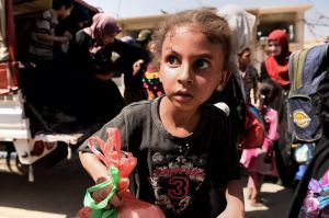 A girl in state of shock arrives with her family at a screening point in western Mosul after being rescued by Iraqi forces.