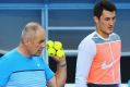 Bernard Tomic listens to his father and coach John Tomic during a practice session before the Australian Open 