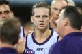 Dockers skipper Nat Fyfe looks on while coach Ross Lyon talks to players.