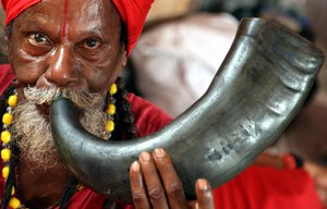 An Indian holy man blows buffalo horn as he waits to register for the Amarnath Yatra, the annual Hindu pilgrimage to the Amarnath shrine, in Jammu, India, 12 July 2017.