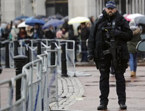 An armed police officer stands in front of Buckingham Palace in London, Monday, Jan. 16, 2017.