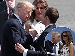 Brothers in arms: French President Emmanuel Macron (L) bids farewell to Donald Trump with a very firm hand shake as Melania watches on after the traditional Bastille Day parade in Paris