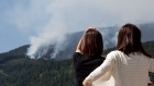 BC Wildfire People stop at gas station to watch mountain burn