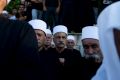 Druze men attend the funeral of Israeli police officer Advanced Staff Sgt. Maj. Kamil Shanan in Hurfeish, Israel, ...