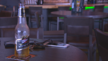 Beer beside keys and phone at Regina bar