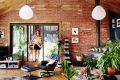 The interior features the warm tones of cork, recycled red brick and Oregon timber, and is filled with indoor plants ...