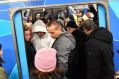 Passengers try to squeeze aboard a packed train during Thursday's rail meltdown.