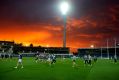 Geelong football team train under the sunset and new lights at Simonds Stadium. 