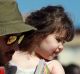 A migrant child is disembarked from the Spanish ship "Open Arms", at Porto Empedocle, Sicily, southern Italy, after ...