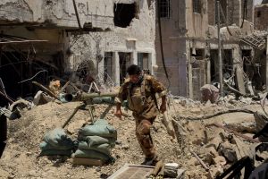 Lieutenant Colonel Saaed Beder Kathem moves away from the blast range of a planned detonation of one of six IEDs on a ...