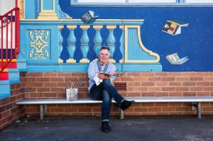 Portrait of French mural artist Hugues Sineux with his latest mural, a classroom at Epping Heights Public School. ...