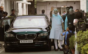 Indian Prime Minister Narendra Modi, second right, greets media along with Bharatiya Janata party president Amit Shah, right, as he arrives for a meeting to name the party's nominee for the post of India's president in New Delhi, India, Monday, June 19, 2017.