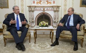 Russian President Vladimir Putin listens to Israeli Prime Minister Benjamin Netanyahu, left, during their meeting in the Novo-Ogaryovo residence, outside Moscow, Russia, Monday, Sept. 21, 2015.