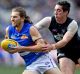 Fast break: Marcus Bontempelli gets past Carlton's Jacob Weitering.