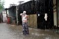 In this Tuesday, July 11, 2017 file photo, a man soaps himself up and takes bath during monsoon rains in Allahabad, ...