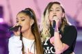 Ariana Grande, left, and Miley Cyrus perform at the One Love Manchester tribute concert in Manchester, England, Sunday, ...