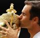 LONDON, ENGLAND - JULY 16: Roger Federer of Switzerland kisses the trophy as he celebrates victory after the Gentlemen's ...