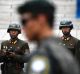 Two North Korean soldiers look across the border at a South Korean counterpart. 