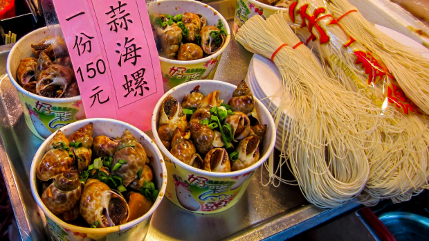 Snails and noodles for sale at Shilin Night Market, Taipei, Taiwan.