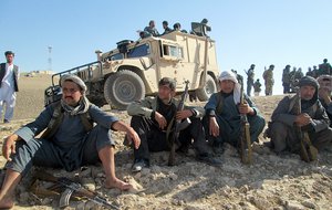 FILE - In this Oct. 1, 2015 file photo, Afghan security forces and volunteer militias rest on their way to Kunduz, Afghanistan to fight Taliban fighters.