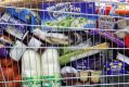 A trolley of own brand and branded goods sits in an aisle inside a Morrisons supermarket, operated by Wm Morrison ...