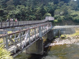 The old historic double-decker road-rail bridge (except that the upper story only carries a walkway these days) leading over the river of the Karangahake Gorge to the rail tunnel, in the Coromandel Peninsula, New Zealand.