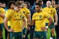 Down and out: Wallabies captain Michael Hooper (front left), Will Genia (front right) and the Wallabies come to terms ...