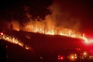 Flames from a backfire burn as CalFire crews battle the Detwiler near Mariposa, Calif., on Tuesday, July 18, 2017. According to fire officials, the blaze has scorched 25,000 acres. (AP Photo/Noah Berger)