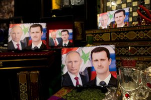 In this Monday, April 18, 2016 photo, porcelain photos decorated with the images of Russian President Vladimir Putin and Syrian President Bashar Assad are displayed in a souvenirs shop in Damascus, Syria. Putin, Assad and Nasrallah are a hot commodity in Damascus these days, their faces posted on mementos in the capital's old bazars. (AP Photo/Hassan Ammar)