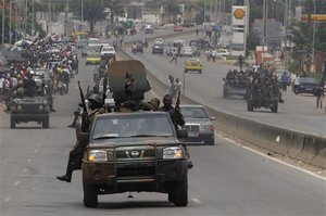 Republican forces soldiers patrol a street in the Cocody neighborhood of Abidjan, Ivory Coast, Wednesday, April 13, 2011.