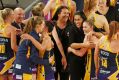 Sunshine Coast Lightning coach Noeline Taurua and her players celebrate after winning the Super Netball major semi-final ...