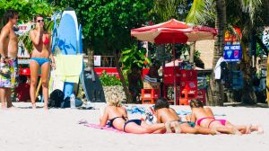 Tourists relax on Kuta Beach.