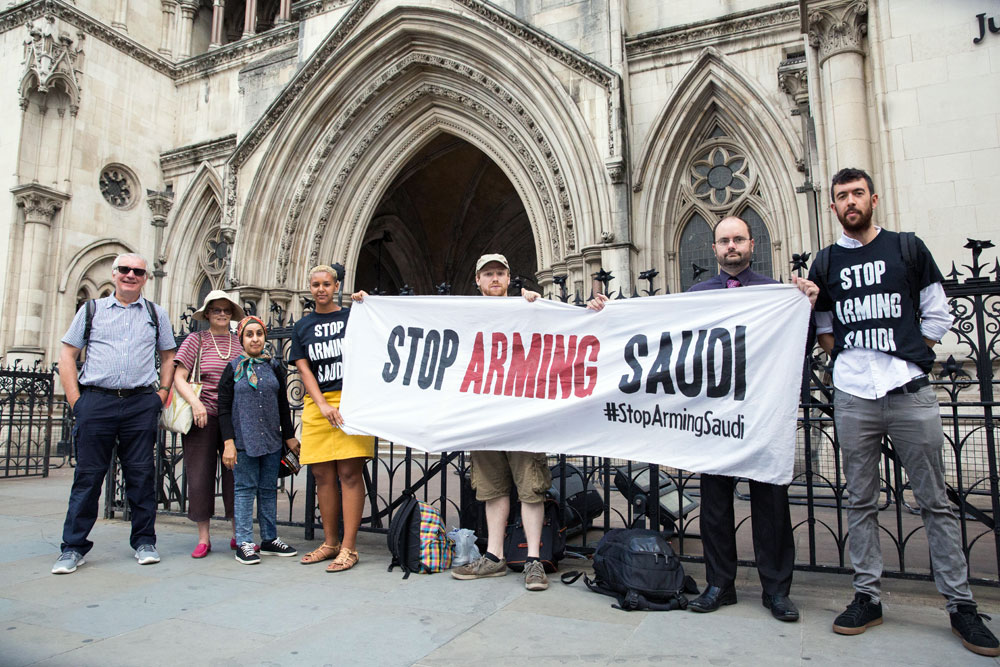 Campaigners outside the High Court with a banner reading “Stop arming Saudi”