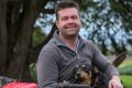 Dairy farmer Jason Smith with Emma, his eight-month-old kelpie.