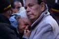 Diane Whittaker (centre) is comforted by Daisy Fernando (right). Both are aunts of Eric Whittaker who died in custody. 