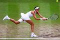 Garbine Muguruza plays a backhand in a winning shot against Venus Williams.