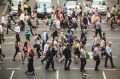 SYDNEY, AUSTRALIA - DECEMBER 22: Pedestrians cross King st and Pitt St, on what should be a bussy Christmas shopping day ...