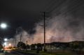 Acrid smoke shrouds the suburb of Dallas last week. More than 115 homes had to be evacuated.