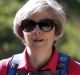 British Prime Minister Theresa May, walks in a forest with her husband Philip at the start of her summer holiday in the ...