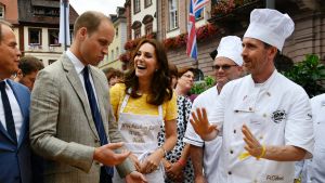 Prince William and the Duchess of Cambridge, listen to explanations by Andreas Goebes, right, of the bakers guild ...