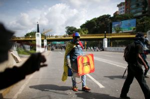 Anti-government demonstrators block a highway during clashes with security forces in Caracas, Venezuela, Sunday, July 9, ...