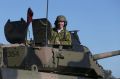 Defence Industry Minister Christopher Pyne, in the turret of an armoured vehicle at Victoria's Puckapunyal army base ...