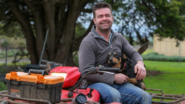 Dairy farmer Jason Smith with Emma, his eight-month-old kelpie.