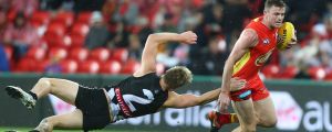 GOLD COAST, AUSTRALIA - JULY 15: Pearce Hanley of the Suns is tackled by Jordan De Goey during the round 17 AFL match ...