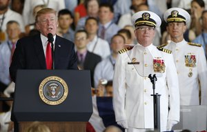 President Donald Trump, left, puts the USS Gerald Ford into commission as Ships commander Capt. Richard McCormack, front right, listens aboard the nuclear aircraft carrier USS Gerald R. Ford for it's commissioning at Naval Station Norfolk in Norfolk, Va., Saturday, July 22, 2017.