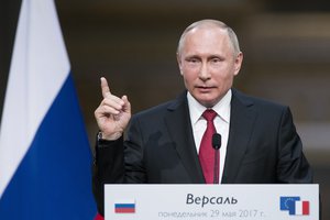 Russian President Vladimir Putin gestures as he speaks at a joint news conference with French President Emmanuel Macron at the Palace of Versailles as they meet for talks before the opening of an exhibition marking 300 years of diplomatic ties between the two countries, in Versailles, near Paris, France, Monday, May 29, 2017.