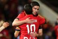 Coolly done: Dylan McGowan congratulates Marcelo Carrusca, who scored the winning goal.