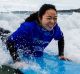 Xiaodan Zhang gets a surfing lesson in Bondi as part of a push to attract more middle class Chinese tourists Photo: ...