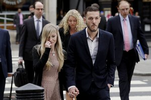 The parents of critically ill baby Charlie Gard, Connie Yates and Chris Gard arrive at the High Court in London, Monday, July 24, 2017. The parents of the 11-month old, who has a rare genetic condition and brain damage, are returning to court for the latest stage in their effort to seek permission to take the child to the United States for medical treatment. (AP Photo/Matt Dunham)